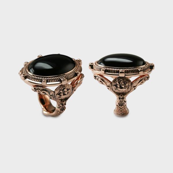 A ring shown in two different angles in rose gold and black onyx.